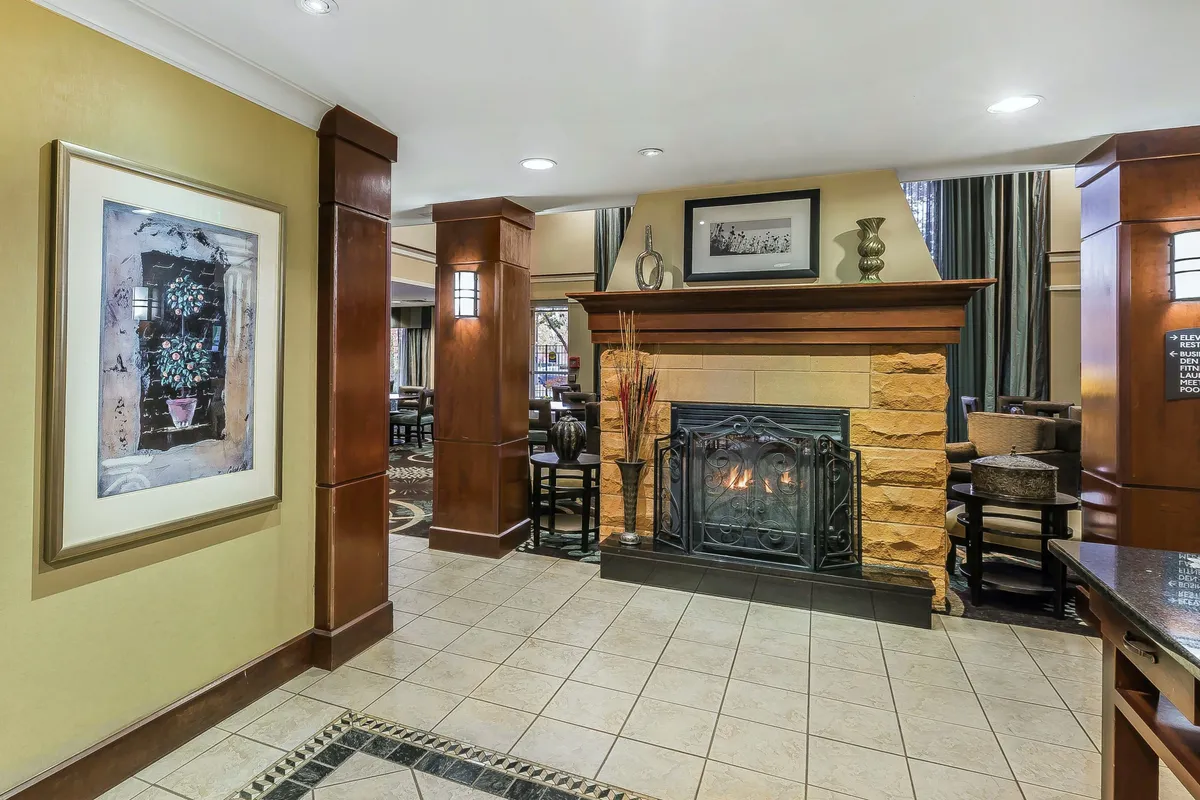 A cozy lounge space with a glowing fireplace, thoughtfully arranged furniture, and unique local artwork. The inviting setting is perfect for families to gather, relax, or share stories after a day of adventure.